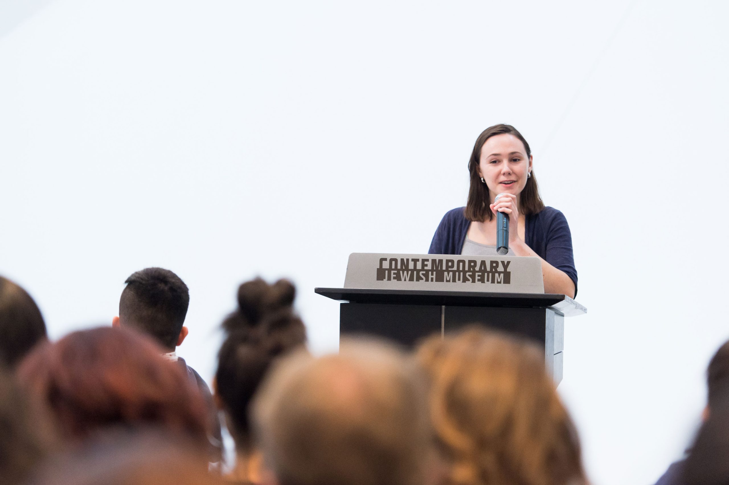 TAC squad member and <em>What We Hold</em> participant Elizabeth Levie speaks about her experience in creating audio stories at the opening reception.