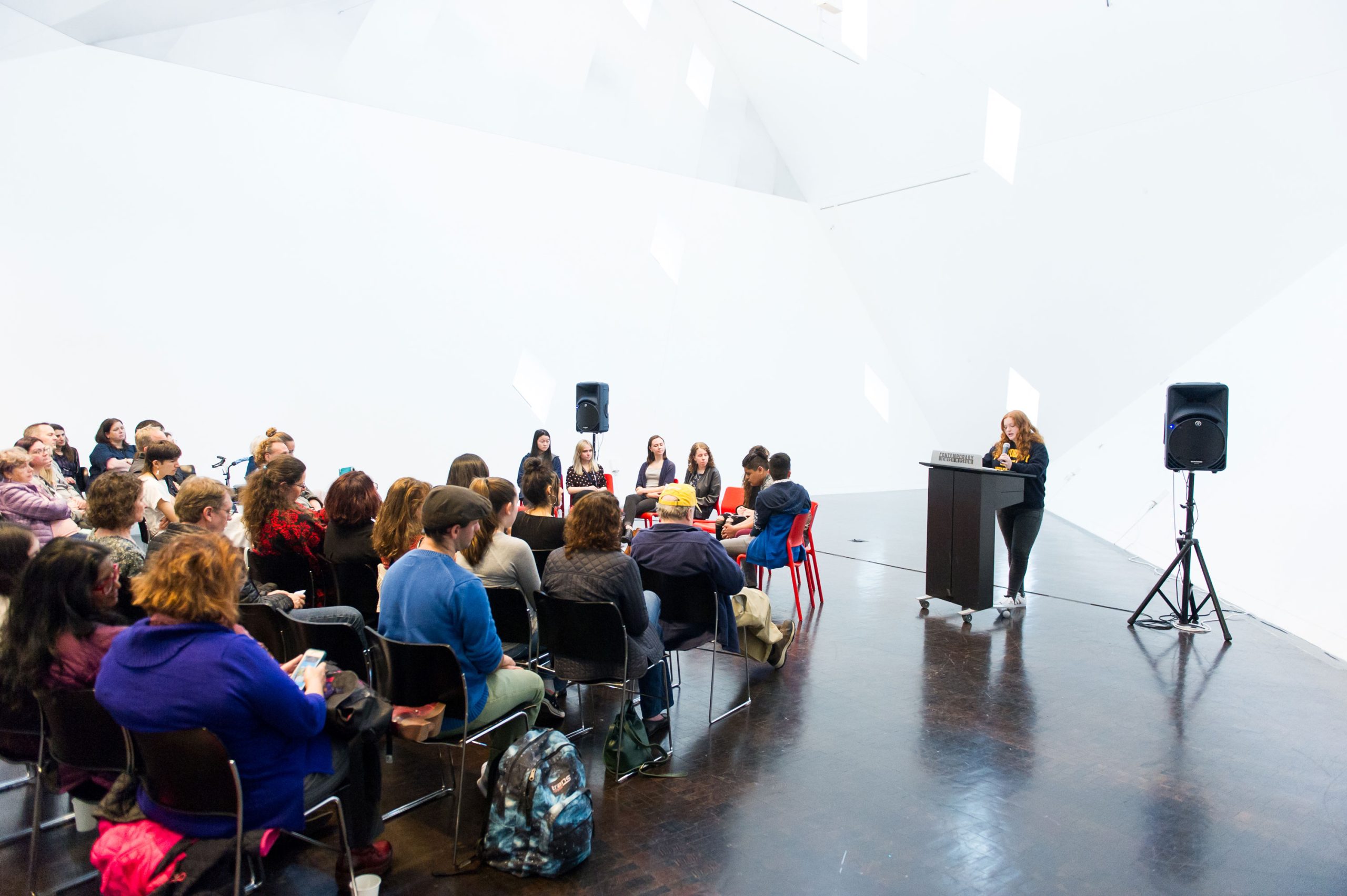 <em>What We Hold</em> participant and Contra Costa Midrasha teen Tamar Franbuch shares the story of her great grandmother at the opening reception.